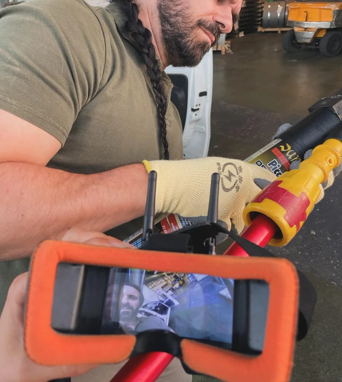Operatore che usa l’asta telescopica robotizzata con il video in diretta sullo smartphone